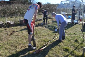 Benjamin, Jenny and Lynn P cutting turfs on the shed site